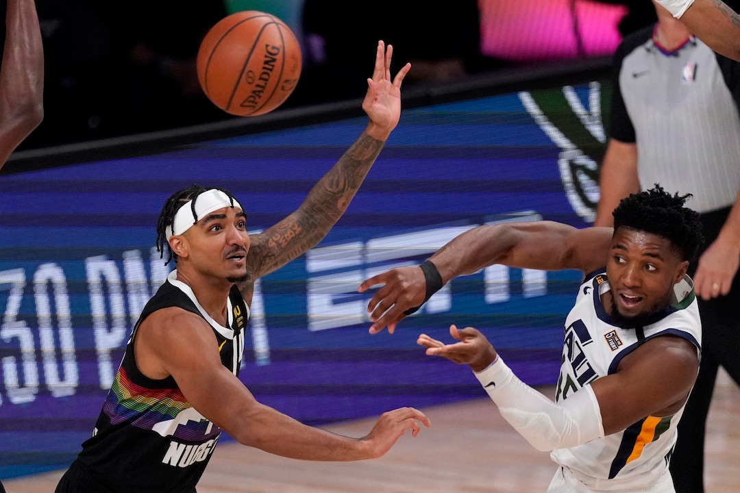 Denver Nuggets' Gary Harris (14) defends against a pass by Utah Jazz's Donovan Mitchell, right, during the first half an NBA first round playoff basketball game, Tuesday, Sept. 1,2020, in Lake Buena Vista, Fla. (AP Photo/Mark J. Terrill)