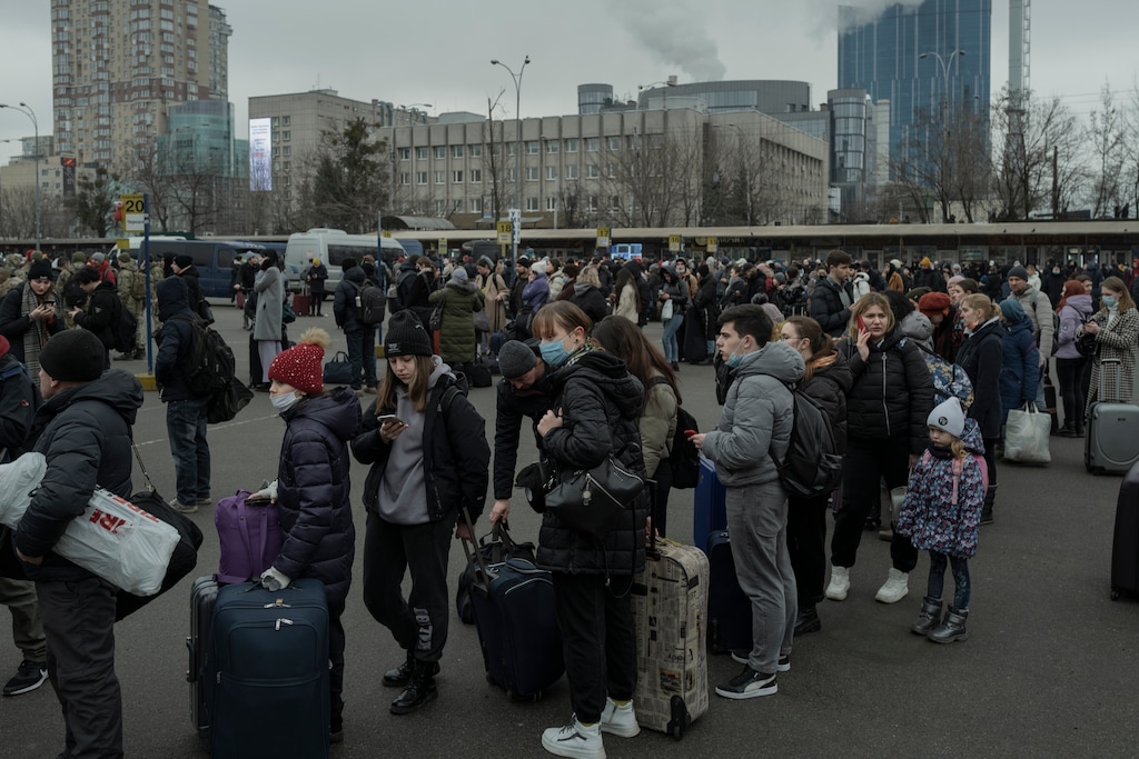 (Emile Ducke | The New York Times) People line up at a long-distance bus station in the center of Kyiv, as Russia's invasion of Ukraine began with rocket attacks here in the capital and in other major cities on the morning of Thursday, Feb. 24, 2022.