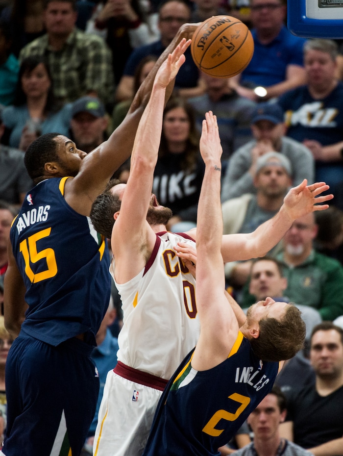 (Rick Egan  |  The Salt Lake Tribune)   Cleveland Cavaliers forward Kevin Love (0) shoots as Utah Jazz forward Derrick Favors (15) and Utah Jazz forward Joe Ingles (2) defend, in NBA action Utah Jazz vs Cleveland Cavaliers, in Salt Lake City,  Saturday, December 30, 2017.


