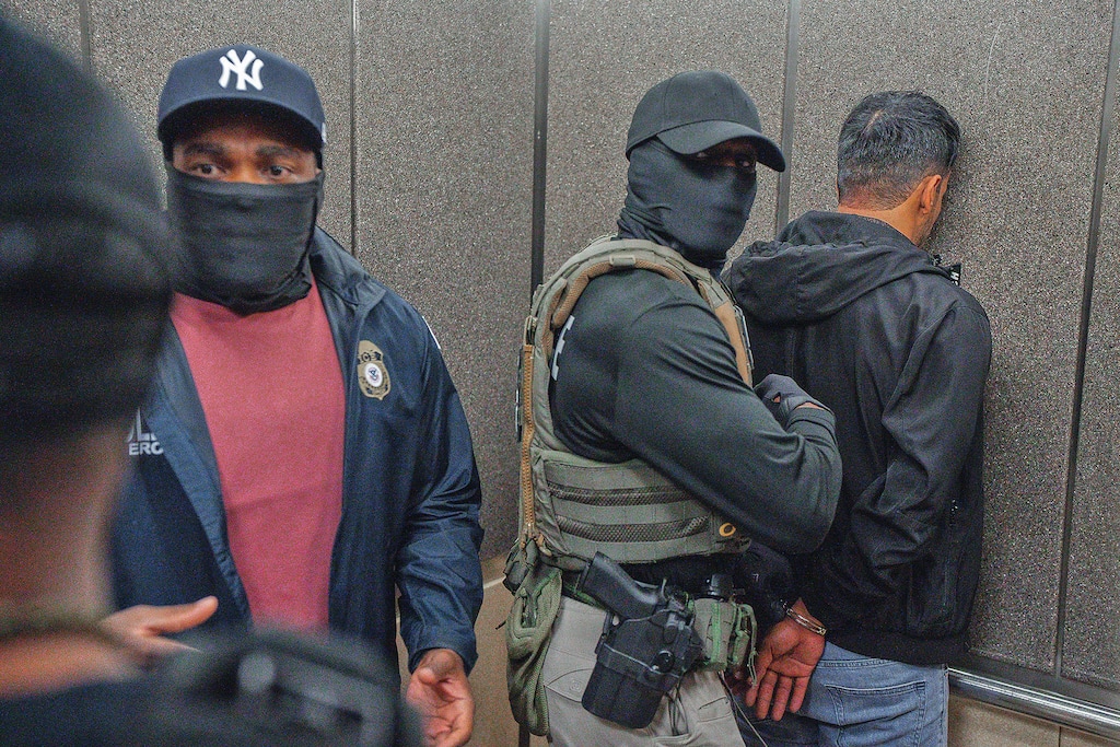 Immigration and Customs Enforcement agents escort a detained immigrant into an elevator after he exited an immigration courtroom, Tuesday, June 17, 2025, in New York. (AP Photo/Olga Fedorova)