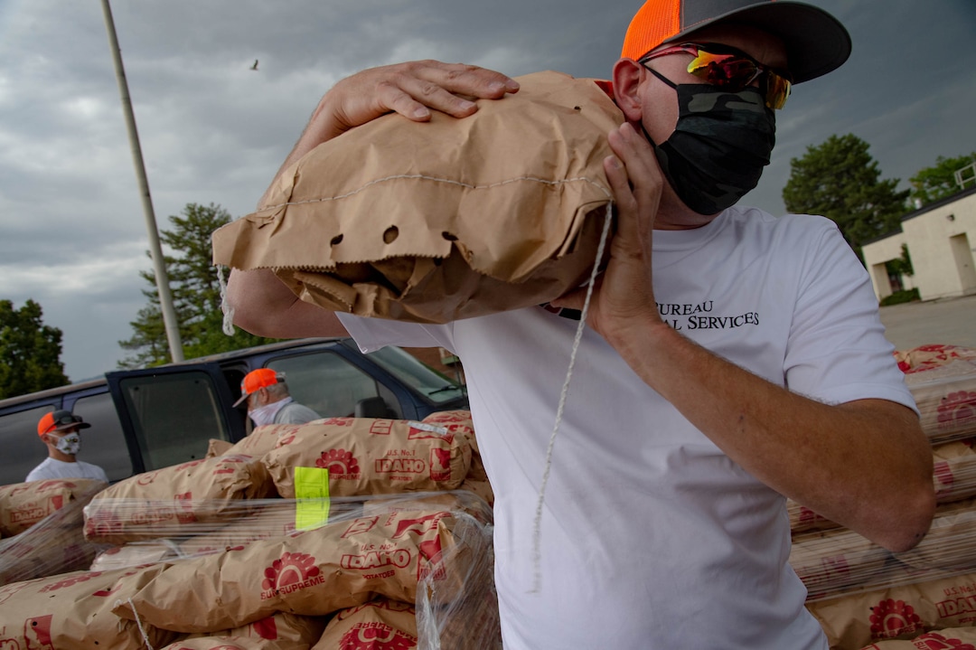(Francisco Kjolseth  |  The Salt Lake Tribune) Nelson Abbott loads 50-pound bags of potatoes in people’s trunks as the third “Miracle Project” for the nonprofit foundation which raises money to purchase food produced by Utah farmers and then gives to residents in need, takes place at the Utah State Fairpark in Salt Lake City on Monday, July 27, 2020. The food donation from the Utah Farm Bureau’s “Farmers Feeding Utah” program provided food for 600 individuals and families who have recently become unemployed due to the coronavirus.