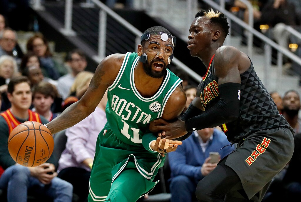 Boston Celtics' Kyrie Irving, left dribbles against Atlanta Hawks' Dennis Schroder, of Germany, in the second quarter of an NBA basketball game in Atlanta, Saturday, Nov. 18, 2017. Boston won 110-99. (AP Photo/David Goldman)