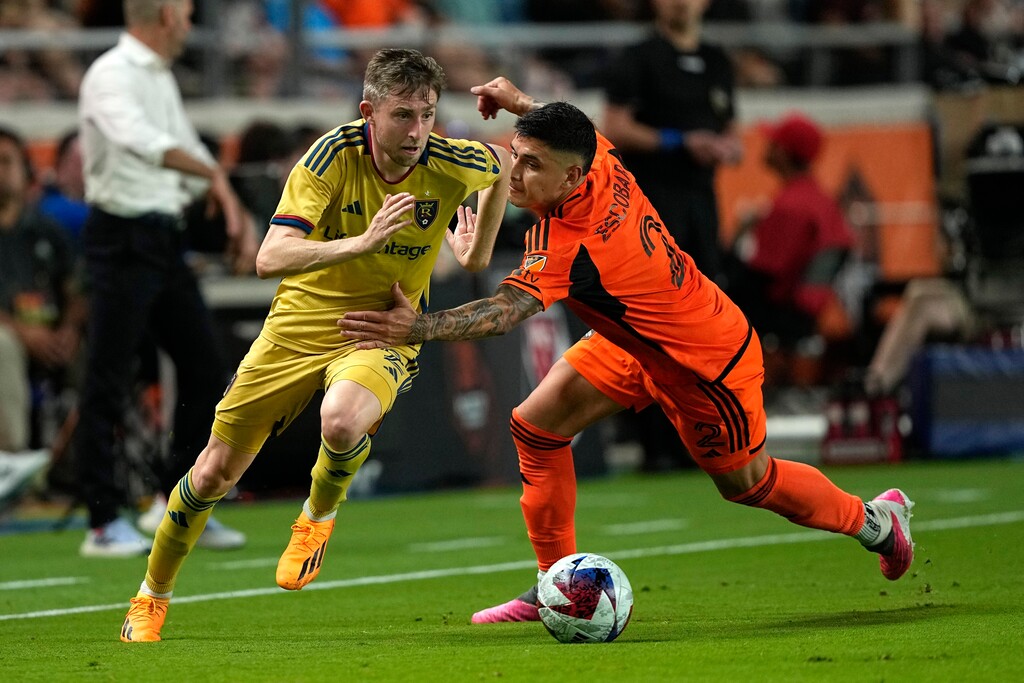 (David J. Phillip | AP) Houston Dynamo's Franco Escobar (2) grabs Real Salt Lake's Andrew Brody during the second half of an MLS soccer match Saturday, May 6, 2023, in Houston. The teams tied 0-0.