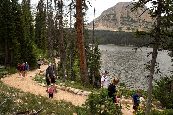 (Leah Hogsten  |  The Salt Lake Tribune)  Visitors to Mirror Lake walk the path around the lake, Aug. 6, 2017. Bald Mountain is in the background.