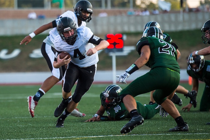 (Chris Detrick  |  The Salt Lake Tribune)    Highland's Cole Peterson (4) runs the ball past Hillcrest's Bassel Tekarli (21) during the game at Hillcrest High School Friday, September 1, 2017. 
