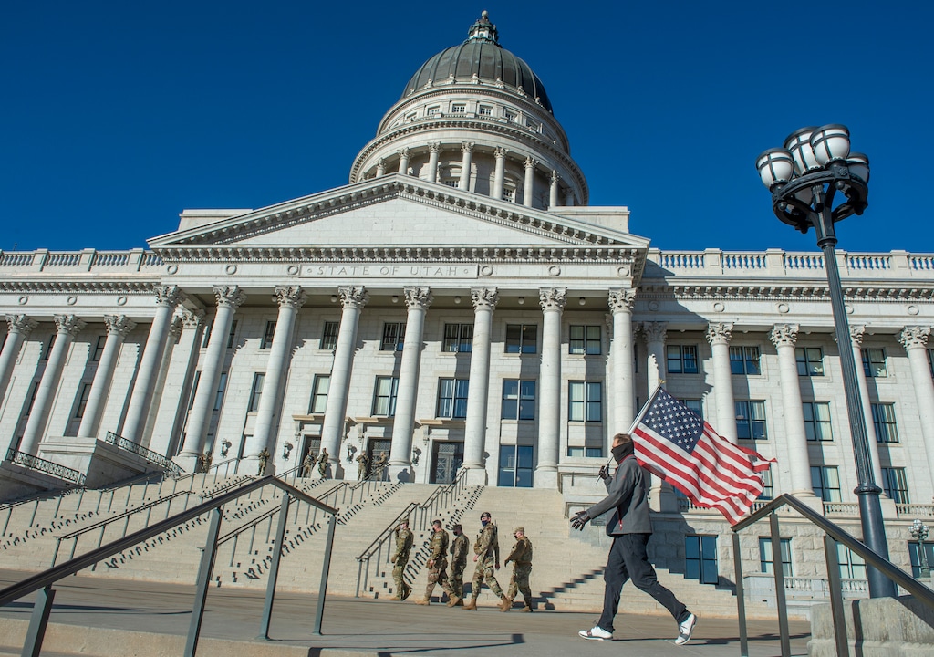 (Rick Egan | The Salt Lake Tribune) Jim White walks back and forth in front of the State Capitol with a tattered American Flag, protesting the corruption politicians and praying that God will change their hearts, on Tuesday Jan. 19, 2021.