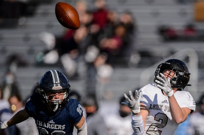 (Trent Nelson  |  The Salt Lake Tribune) Lone Peak's Weston Covey pulls in a pass ahead of Corner Canyon's Scott Iverson during the 6A state football championship game at Cedar Valley High School in Eagle Mountain on Friday, Nov. 20, 2020.