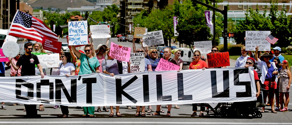 (AP Photo/Rick Bowmer, File)

In this June 27, 2017, photo, protesters block a street during a protest against the Republican bill in the U.S. Senate to replace President Barack Obama's health care law, in Salt Lake City. The Trump administration will allow Medicaid expansion with a work requirement in Utah, a decision that came Dec. 23, despite courts taking a dim view of the requirement in other states.