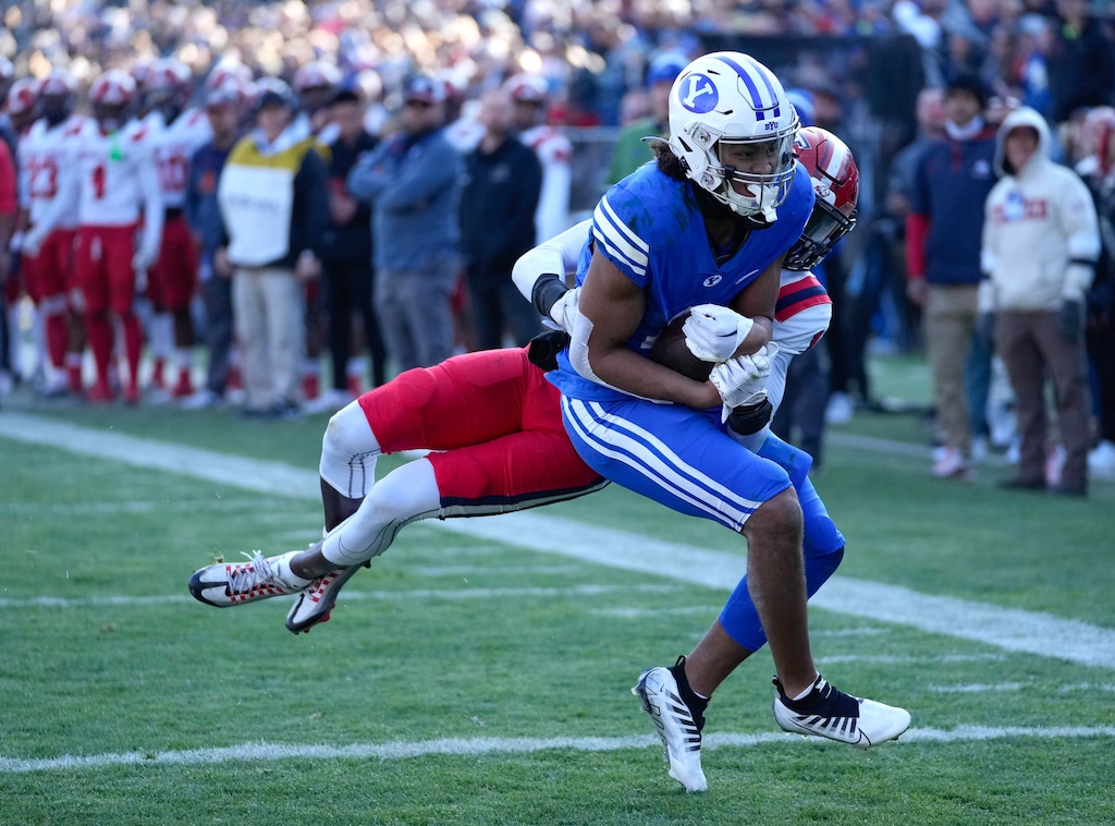 (Francisco Kjolseth | The Salt Lake Tribune) Brigham Young Cougars wide receiver Keanu Hill (1) brings Utah Tech's Deven Osborne (1) across the end zone for his third touchdown of the game in football action between the Brigham Young Cougars and the Utah Tech Trailblazers at LaVell Edwards Stadium in Provo, Saturday, Nov. 19, 2022.