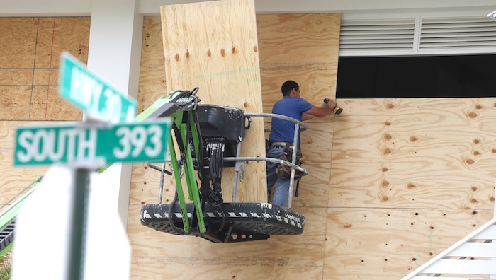 (Michael Snyder | Northwest Florida Daily News | The Associated Press) Workers finish boarding up the upper level of Shunk Gulley Oyster Bar at Gulf Place on Tues. Oct. 9, 2018 in Santa Rosa Beach, Fla., ahead of Hurricane Michael's possible landfall in the next 24 hours in South Walton County.