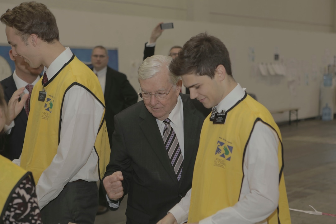 (The Church of Jesus Christ of Latter-day Saints) M. Russell Ballard observes missionaries assembling hygiene kits for guests of a refugee shelter in Berlin.