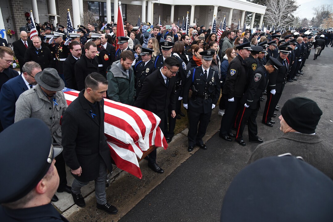 (Francisco Kjolseth  |  The Salt Lake Tribune)  Friends of police officer David Romrell carry his casket away for planned cremation following funeral services at Larkin Sunset Gardens Cemetery in Sandy, Wed. Dec. 5, 2018.