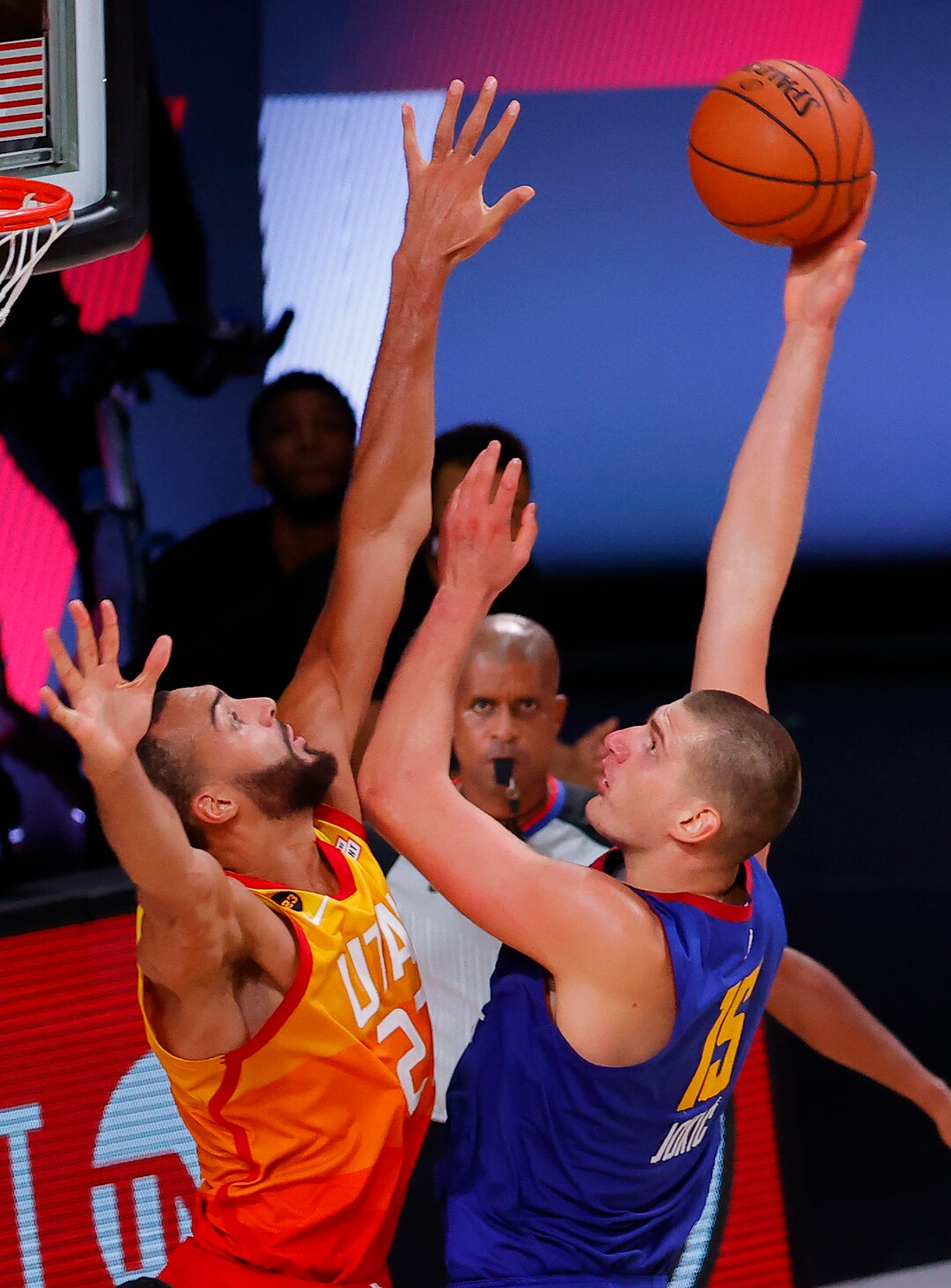 Denver Nuggets' Nikola Jokic, right, goes up for a shot against Utah Jazz's Rudy Gobert during the third quarter of Game 4 of an NBA basketball first-round playoff series, Sunday, Aug. 23, 2020, in Lake Buena Vista, Fla. (Kevin C. Cox/Pool Photo via AP)