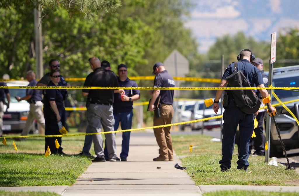 (Chris Samuels | The Salt Lake Tribune) Police investigate a shooting that occurred outside a meetinghouse of The Church of Jesus Christ of Latter-day Saints in Kearns, Monday, Aug. 17, 2026. A father and son were charged with murder on Thursday in connection with the shooting.