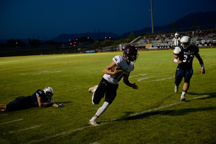 (Francisco Kjolseth  |  The Salt Lake Tribune)  Jordan quarterback Crew Wakley runs the ball into the end zone for a touchdown in the third quarter against Syracuse in game action at Syracuse on Thursday, Aug. 24, 2017.
