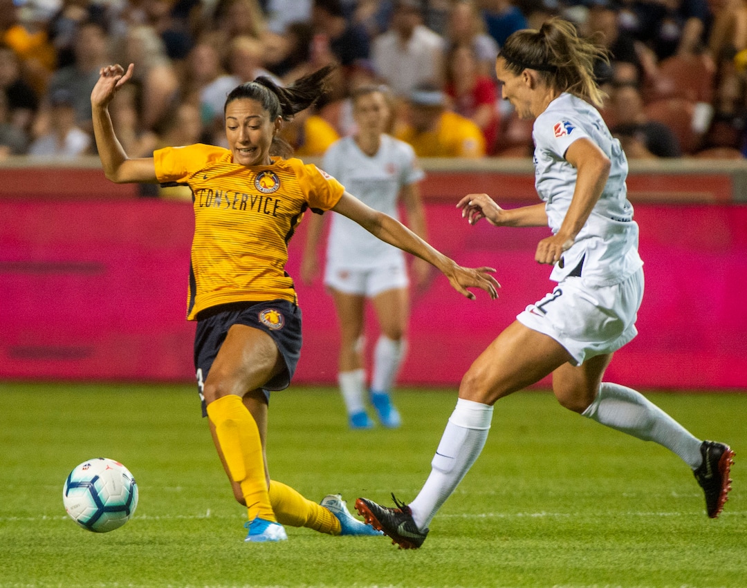(Rick Egan  |  The Salt Lake Tribune)     Utah Royals FC forward Christen Press (23) kicks the ball, as Portland Thorns FC defender Katherine Reynolds (2) defends, in Soccer action between Utah Royals FC and Portland Thorns FC, in Sandy, Friday, July 19, 2019.