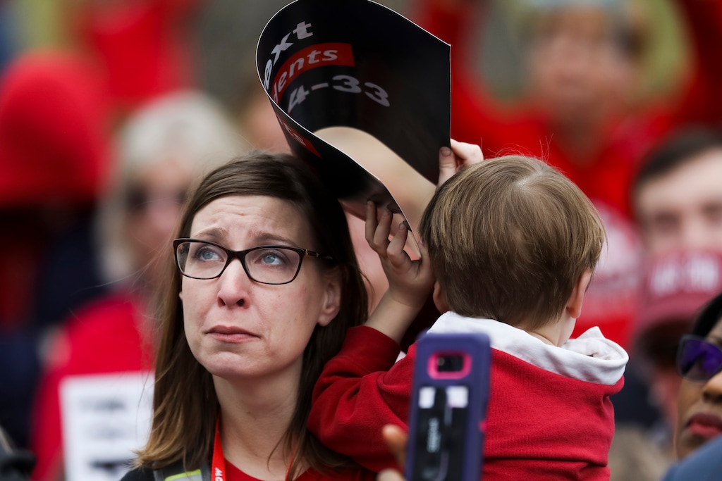 Holly Blastic, 37, holds her son Henry Schroetlin, 5, during a rally outside the State Capitol ahead of the House's plan to hold votes on several gun control proposals Wednesday Feb. 28, 2018, in Springfield, Ill. (Armando L. Sanchez/Chicago Tribune)