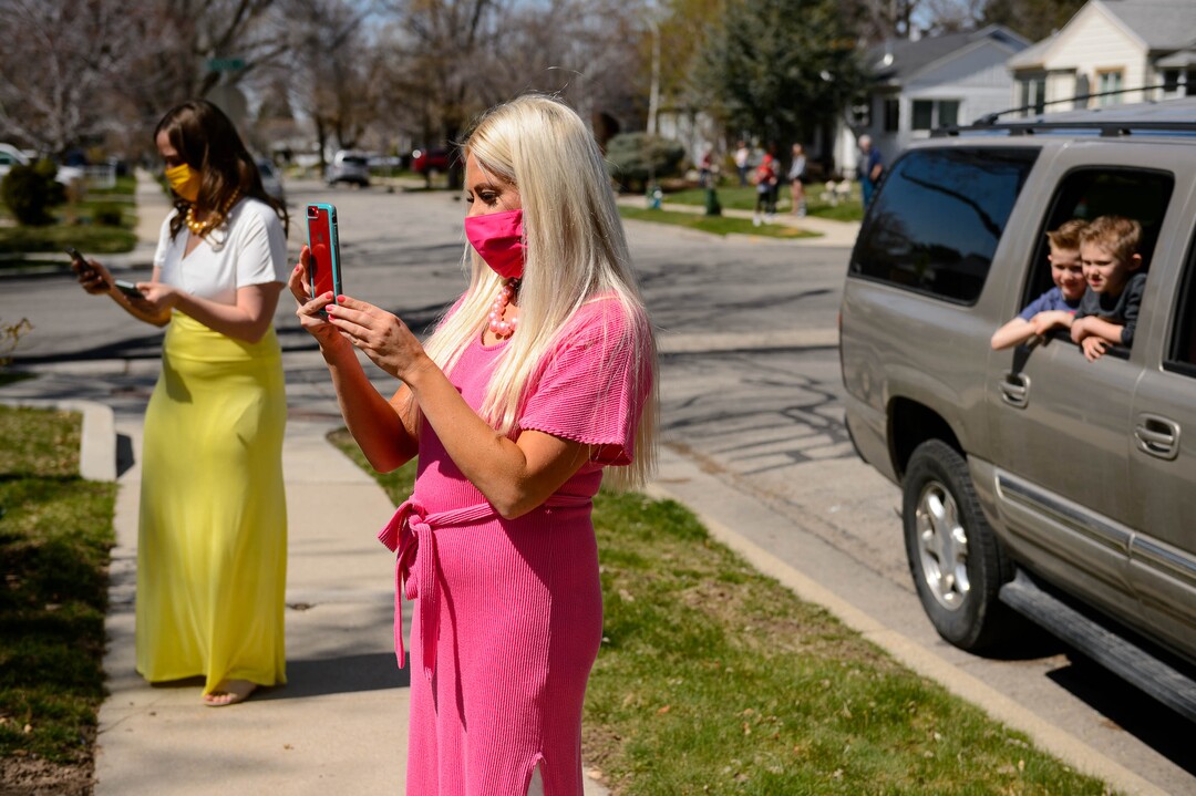 (Trent Nelson  |  The Salt Lake Tribune) Colored coordinated masks, a Facebook livestream, and relatives watching from the car as Kadie and Tyler van Roosendaal are married in a Salt Lake City yard on Saturday, April 4, 2020.