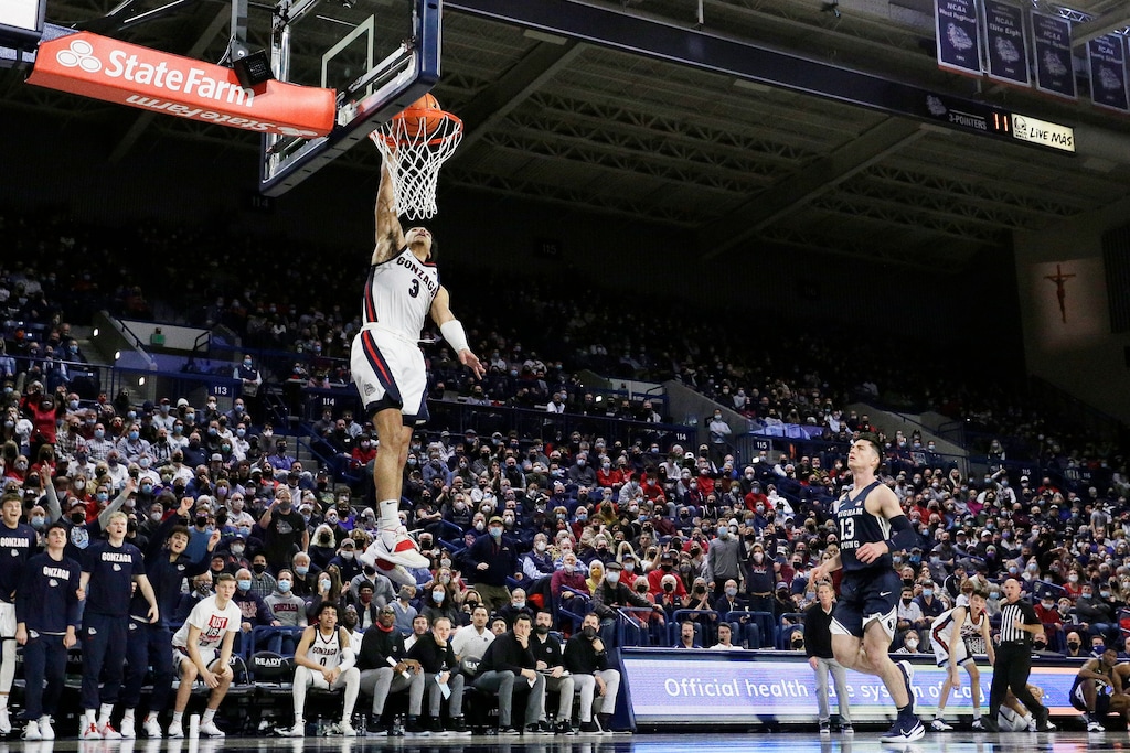 Gonzaga guard Andrew Nembhard (3) dunks in front of BYU guard Alex Barcello (13) during the second half of an NCAA college basketball game, Thursday, Jan. 13, 2022, in Spokane, Wash. Gonzaga won 110-84. (AP Photo/Young Kwak)