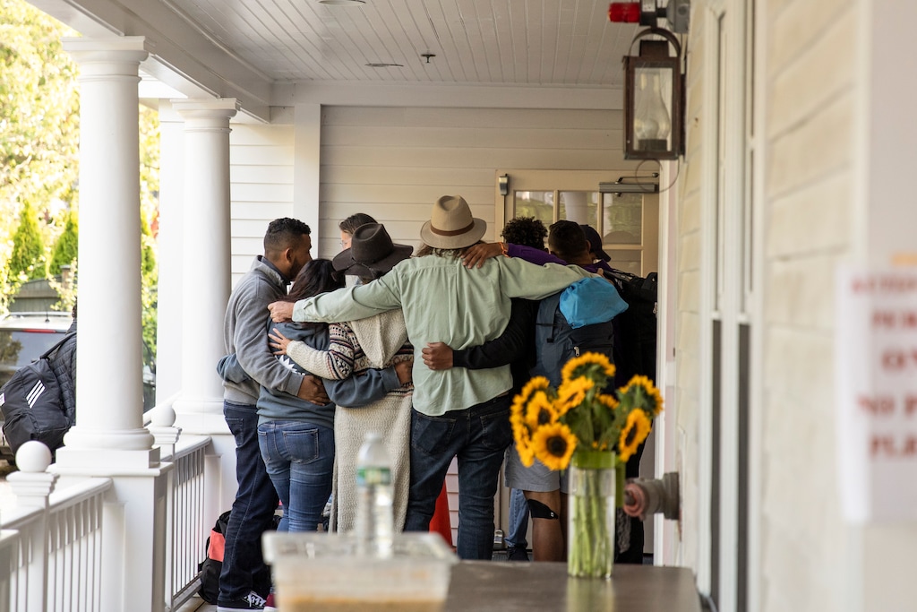 (Matt Cosby | The New York Times)

Migrant families say farewell to volunteers before boarding a bus that will take them to the ferry, on Martha’s Vineyard in Edgartown, Mass. on Friday, Sept. 16, 2022. Migrants shipped to Martha’s Vineyard by Florida’s Republican governor said on Friday that they had been misled about where they were being taken, prompting immigration lawyers to promise legal action as the refugees from Venezuela were relocated temporarily to a federal military base.