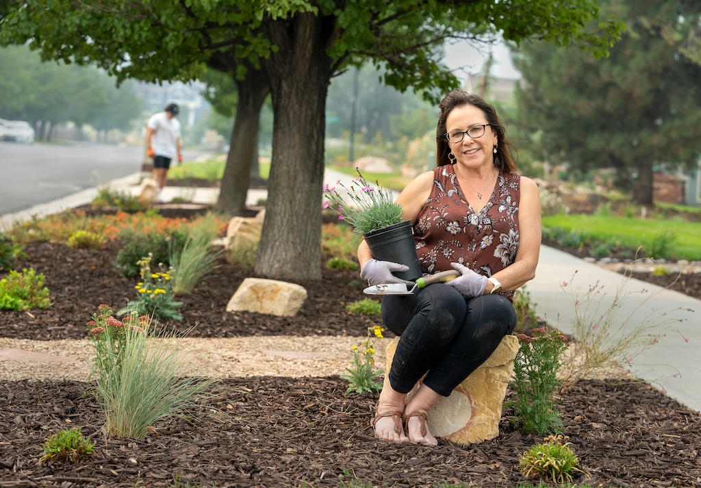 (Leah Hogsten | The Salt Lake Tribune) "I really believe in the program," said Cindi Griwald with her son Collin, 21, who helped. "It's the smartest thing to do. We're in a drought in a desert region." With the help of state-run rebate and incentive programs, Draper resident Griswald  thinks she got 80% of her money back to change her grass parking strips into a colorful, water-wise landscape, Aug. 6, 2021. 