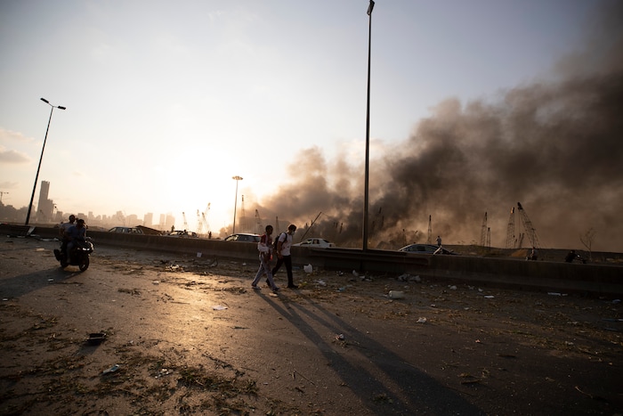 A smoke from a massive explosion is seen in in Beirut, Lebanon, Tuesday, Aug. 4, 2020. Massive explosions rocked downtown Beirut on Tuesday, flattening much of the port, damaging buildings and blowing out windows and doors as a giant mushroom cloud rose above the capital. Witnesses saw many people injured by flying glass and debris. (AP Photo/Hassan Ammar)