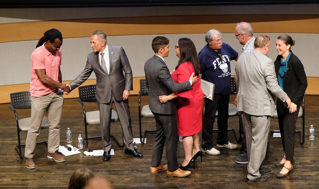 (Francisco Kjolseth  |  The Salt Lake Tribune)  All eight of the candidates for Salt Lake City mayor shake hands and embrace following their debate at the Salt Lake City Library on Wed. June 26, 2019.