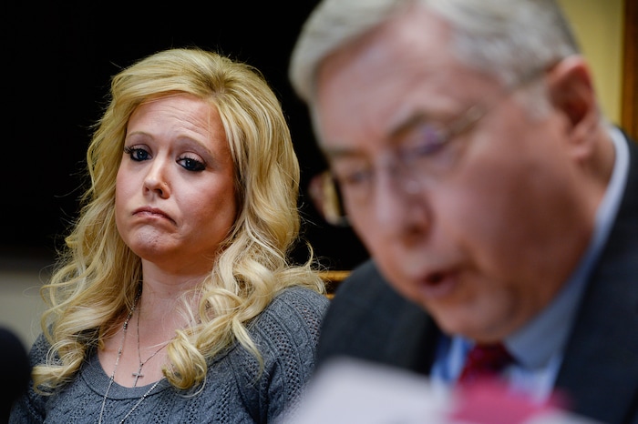 (Francisco Kjolseth | The Salt Lake Tribune) Heather Leyva, listens as her attorney Robert Sykes, discusses the sexual harassment lawsuit he is filing on her behalf against Utah trooper Sgt. Blaine Robbins, during a press conference at his law offices in Salt Lake City Wed. Feb. 7, 2018. According to the lawsuit, the Patrol trooper hounded her with unwanted sexually charged messages and used his position and authority to stalk her.