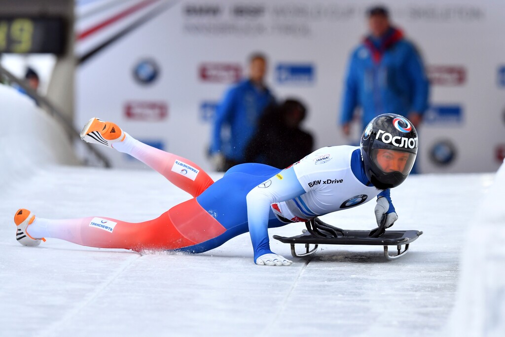 FILE - In this Dec. 15, 2017 file photo Russia's Alexander Tretiakov struggles to start his first run in the men's Skeleton World Cup race in Innsbruck, Austria. The Court of Arbitration for Sport ruled on Thursday, Feb. 1, 2018 to reinstate Tretiakov as gold medal winner of the men's skeleton at the 2014 Sochi Winter Olympics. (AP Photo/Kerstin Joensson, file)