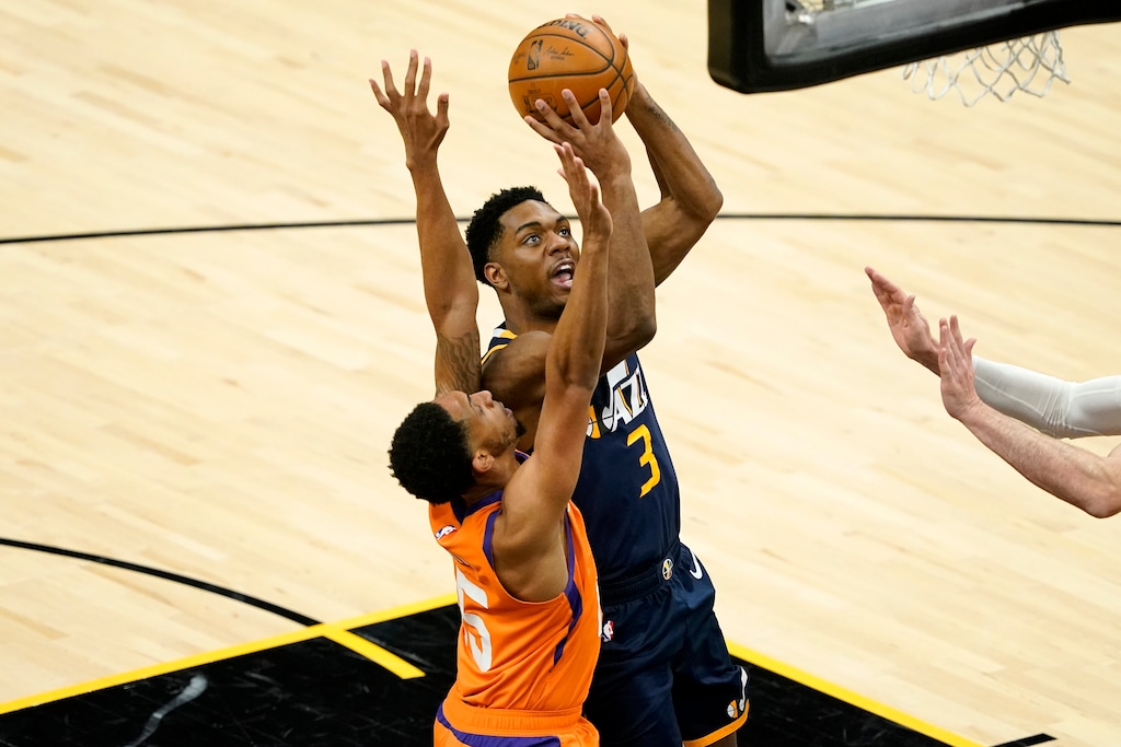 Utah Jazz guard Trent Forrest (3) shoots as Phoenix Suns guard Cameron Payne defends during the first half of an NBA basketball game, Friday, April 30, 2021, in Phoenix. (AP Photo/Matt York)