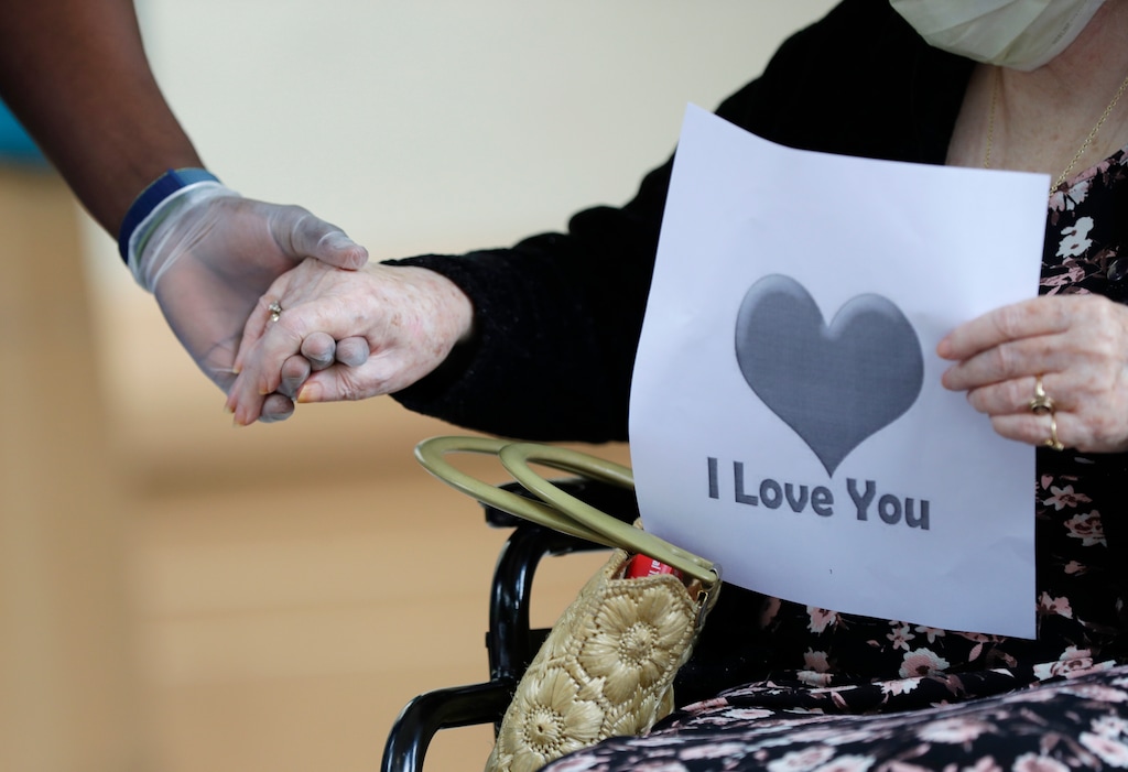 (Wilfredo Lee | AP photo)

In this July 17, 2020, photo, a senior citizen holds the hand of a care coordinator at a health facility in Miami.