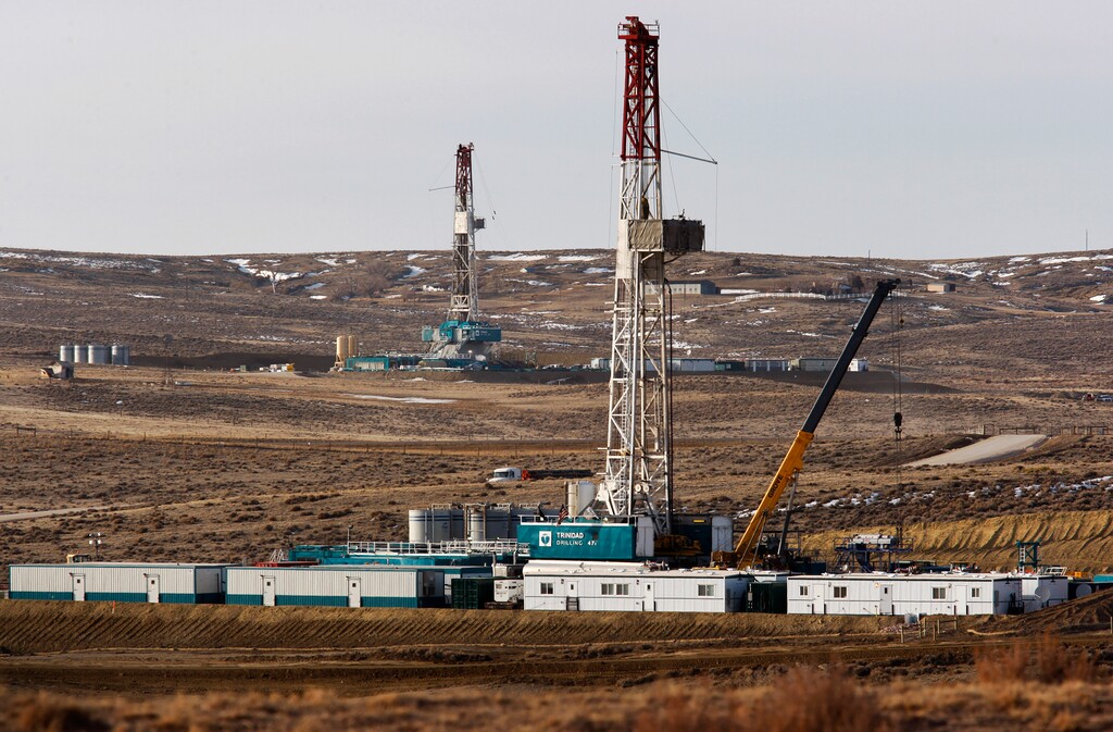 (Leah Millis | The Casper Star-Tribune via AP, file) In this March 5, 2013, file photo, Trinidad Drilling rigs stand near Highway 59 outside Douglas, Wyo. In the closing months of the Trump administration, energy companies stockpiled enough drilling permits for western public lands to keep pumping oil for years. That stands to undercut President-elect Joe Biden's plans to block new drilling on public lands to address climate change.