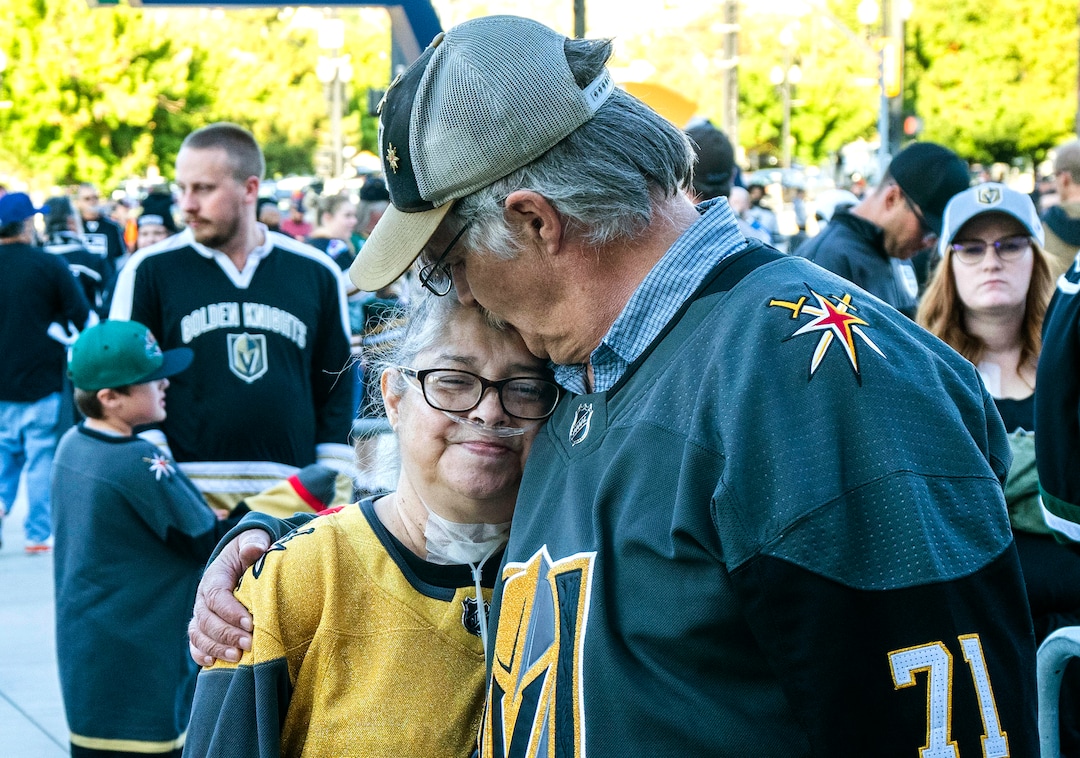 (Rick Egan | The Salt Lake Tribune) Jeff Lewis give this wife Tina a kiss as they wait for the doors to open for the Hockey game at Vivint Arena, between the LA Kings and the Las Vegas Knights, on Tina's first night out after coming home from the hospital, Thursday, Sept. 30, 2021. The Lewis family are avid hockey fans, and their favorite team is the Las Vegas Knights.  The hockey tickets were purchased last spring, when Tina's outlook did not look good.