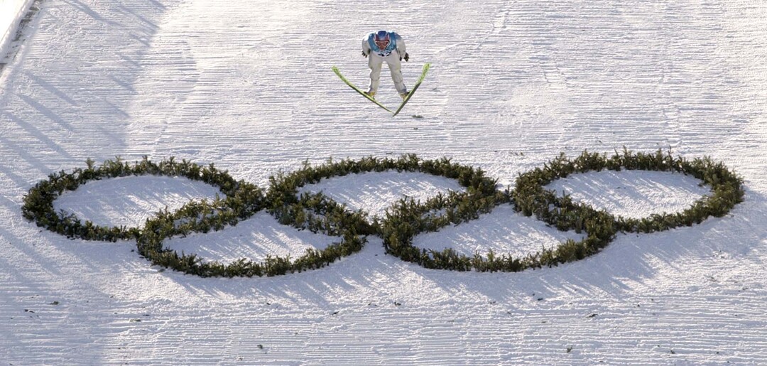 (Trent Nelson  |  The Salt Lake Tribune) American Todd Lodwick flies over the Olympic rings in the final round of the Nordic Combined K90 ski jump, 2002 Olympic Winter Games. Lodwick placed seventh in today's competition.