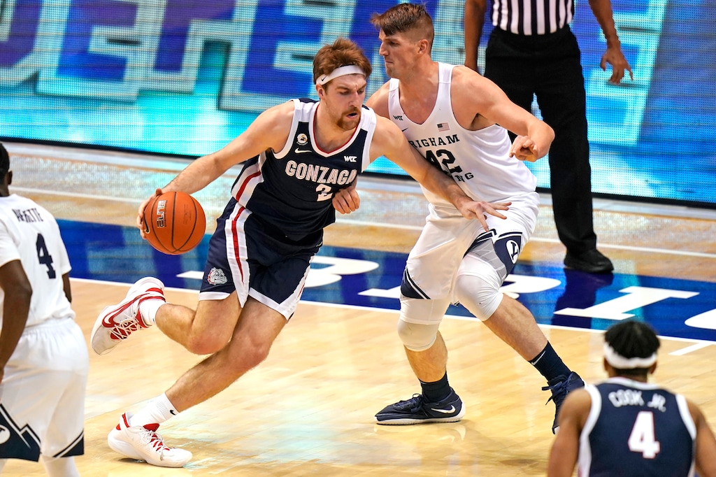 Gonzaga forward Drew Timme (2) drives as BYU center Richard Harward (42) defends in the first half of an NCAA college basketball game, Monday, Feb. 8, 2021, in Provo, Utah. (AP Photo/Rick Bowmer)