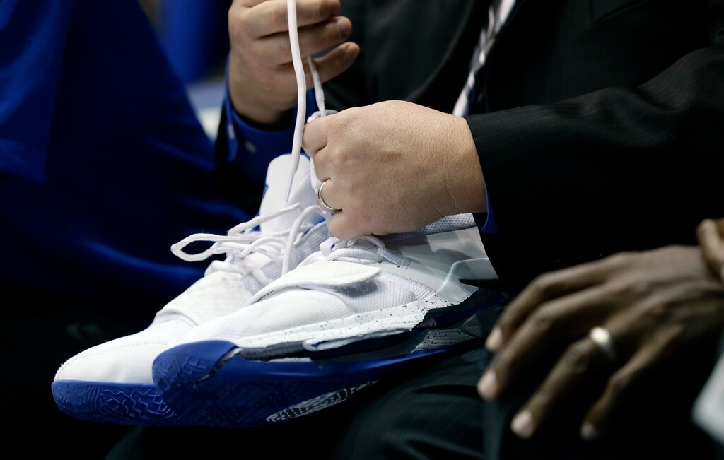 A trainer holds Duke's Zion Williamson's shoes after Williamson left the game due to an injury during the first half of an NCAA college basketball game against North Carolina in Durham, N.C., Wednesday, Feb. 20, 2019. Duke might have to figure out what the Zion Show will look like without its namesake. All because of a freak injury to arguably the most exciting player in college basketball. As his Nike shoe blew out, Williamson sprained his right knee on the first possession of what became top-ranked Duke's 88-72 loss to No. 8 North Carolina. (AP Photo/Gerry Broome)