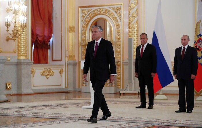 U.S. Ambassador Jon Huntsman walks after presenting credentials to Russian President Vladimir Putin, right, during a ceremony in the Kremlin in Moscow, Russia, on Tuesday, Oct. 3, 2017. The new U.S. Ambassador to Russia presented his credentials to President Vladimir Putin in the Kremlin on Monday amid investigations into Moscow's meddling in the 2016 U.S. elections. Russian Foreign Minister Sergey Lavrov is 2nd right. (AP Photo/Pavel Golovkin, Pool)