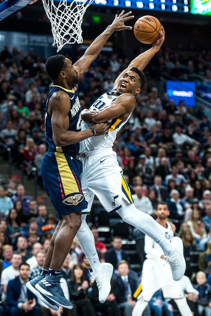(Chris Detrick  |  The Salt Lake Tribune)  Utah Jazz guard Donovan Mitchell (45) is fouled by New Orleans Pelicans guard Tony Allen (24) as he attempts to dunk during the game at Vivint Smart Home Arena Friday, December 1, 2017.  