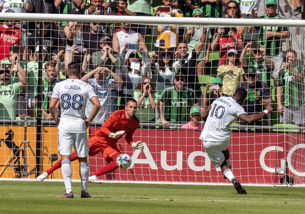 Real Salt Lake forward Sergio Cordova (10) scores a goal on a free kick while defended by Austin FC goalie Brad Stuver, center, during the first half an MLS playoff soccer match, Sunday, Oct. 16, 2022, in Austin, Texas. (AP Photo/Michael Thomas)