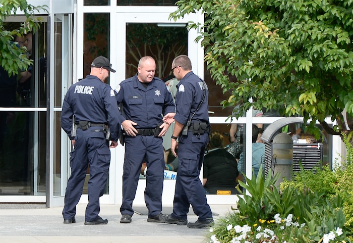 (Francisco Kjolseth  |  The Salt Lake Tribune)  Police gather outside where activists stage a protest against a private prison company with contracts to hold undocumented immigrants on Thursday, July 12, 2018, after locking themselves in the lobby at the headquarters of Management and Training Corporation in Centerville.