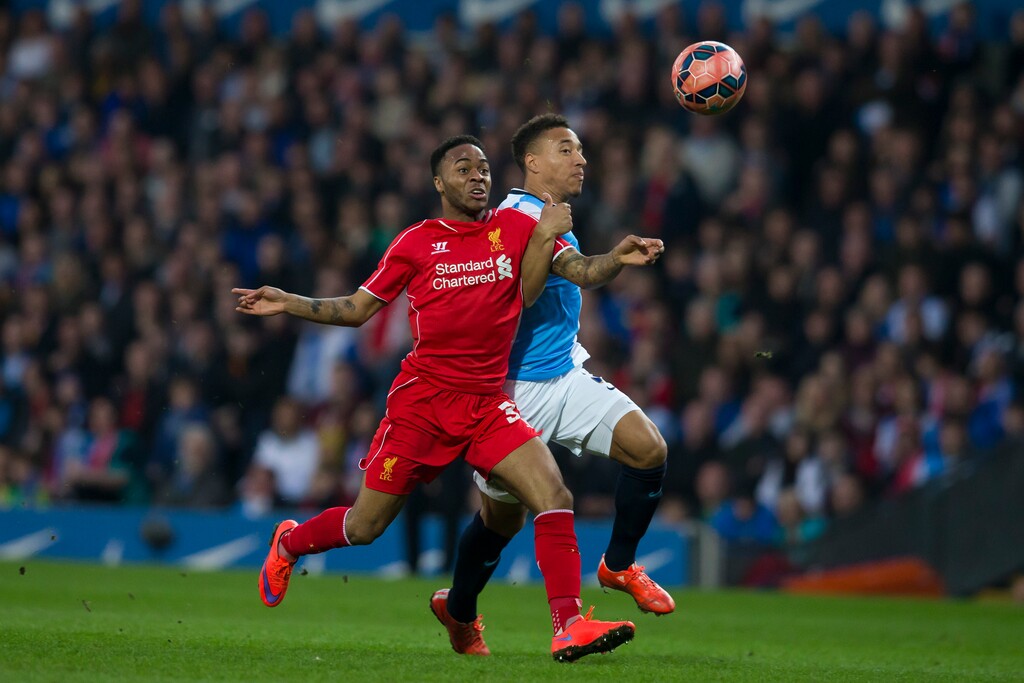 Blackburn's Adam Henley, right, fights for the ball against Liverpool's Raheem Sterling during the English FA Cup sixth round replay soccer match between Blackburn and Liverpool at Ewood Park Stadium, Blackburn, England, Wednesday, April 8, 2015. (AP Photo/Jon Super)  