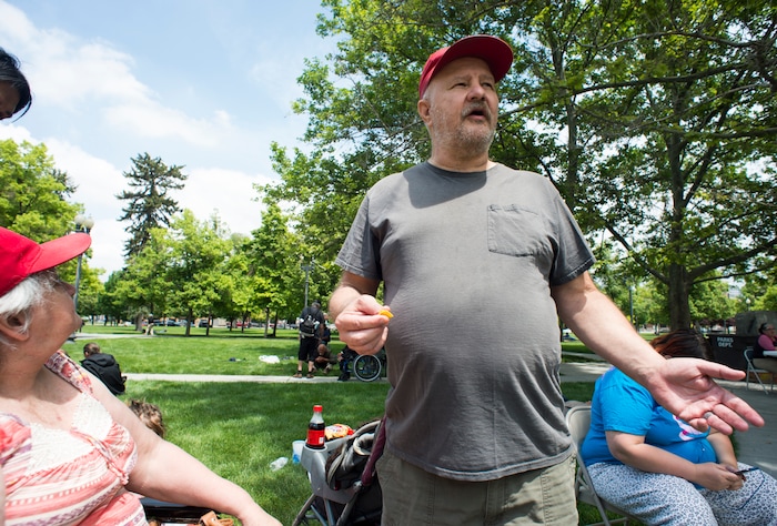(Rick Egan  |  The Salt Lake Tribune)      
Sugar House residents, Janice and Derek Mullins, talk about how they met three years ago this weekend, when they were both homeless. They returned to Pioneer park to visit friends, as the Salt Lake City Mission fed and donated clothes to the homeless in Pioneer Park on Memorial day, Monday, May 28, 2018.


