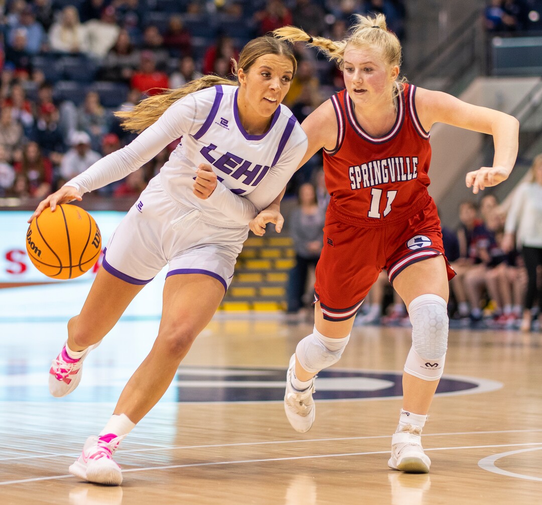 (Rick Egan | The Salt Lake Tribune) Lehi forward, Jamisyn Heaton (44) takes the ball downcourt, as Springville Red Devils, Ashleigh Mousser (11) defends, in the girls 5A State Championship game between the Springville Red Devils and the Lehi Pioneers, at the Marriott Center in Provo, on Saturday, March 5, 2022. 
