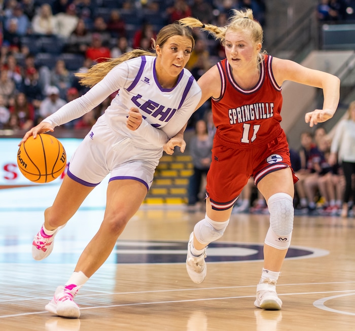 (Rick Egan | The Salt Lake Tribune) Lehi forward, Jamisyn Heaton (44) takes the ball downcourt, as Springville Red Devils, Ashleigh Mousser (11) defends, in the girls 5A State Championship game between the Springville Red Devils and the Lehi Pioneers, at the Marriott Center in Provo, on Saturday, March 5, 2022. 
