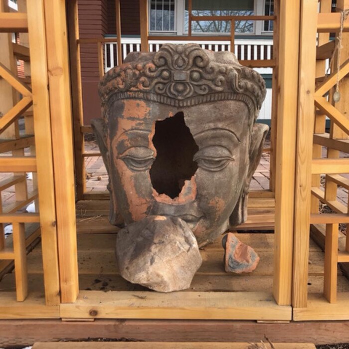 (Photo courtesy Ben Dieterle) A vandal threw a large rock through this $3,000 terra cotta Buddha head early Wednesday at the popular “Buddha on 9th” shrine in Salt Lake City. The owner is raising donations to repair or replace the artwork.