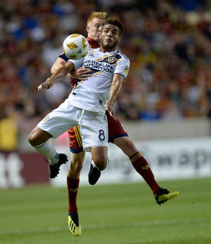 (Francisco Kjolseth  |  The Salt Lake Tribune)  Real Salt Lake defender Justen Glad (15) and Los Angeles Galaxy midfielder Jonathan dos Santos (8) battle it out during the first half of the MLS soccer match Saturday, Sept. 1, 2018, in Sandy at Rio Tinto Stadium.