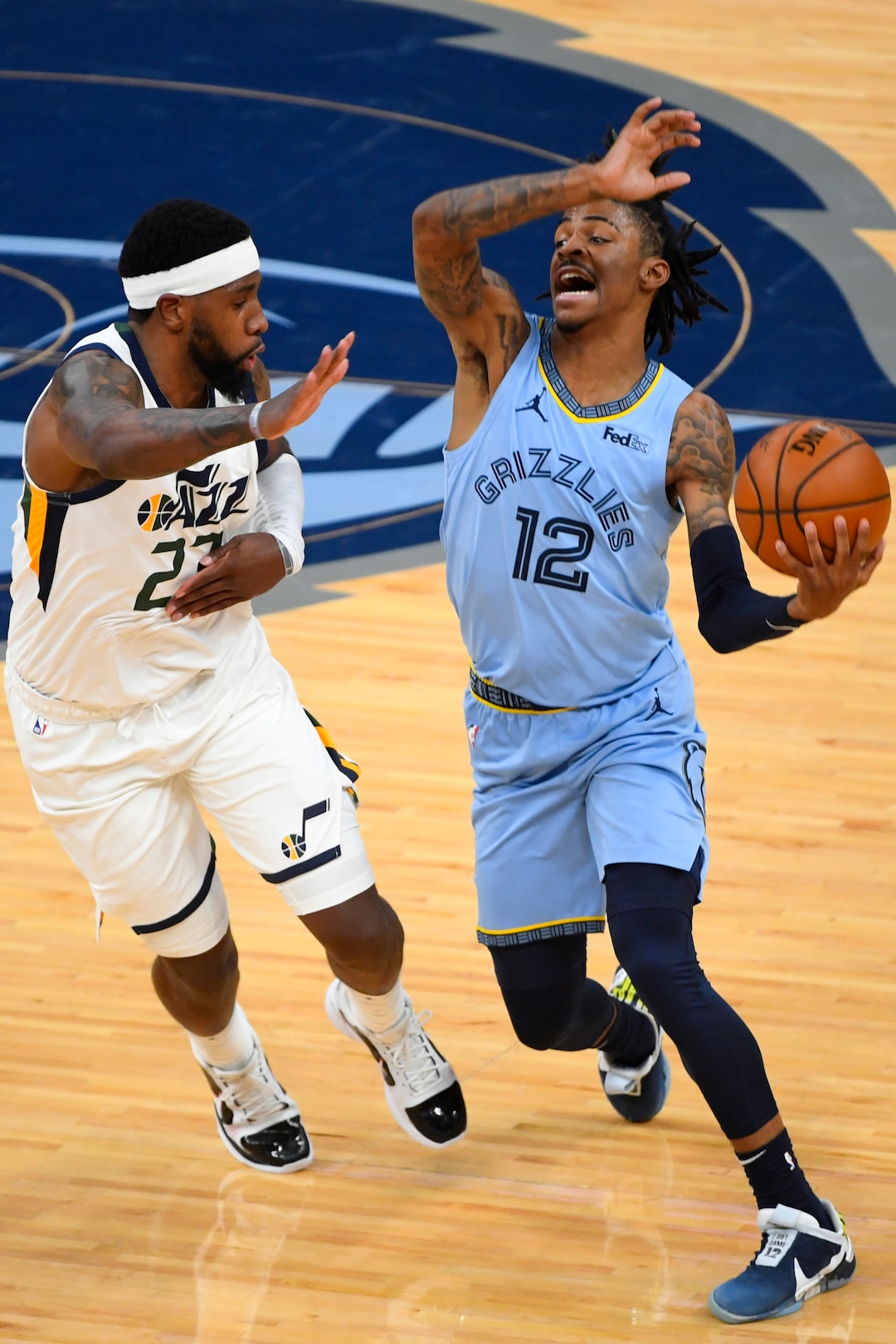 Memphis Grizzlies guard Ja Morant (12) tries to get past the defense of Utah Jazz forward Royce O'Neale during the first half of Game 3 of an NBA basketball first-round playoff series Saturday, May 29, 2021, in Memphis, Tenn. (AP Photo/John Amis)