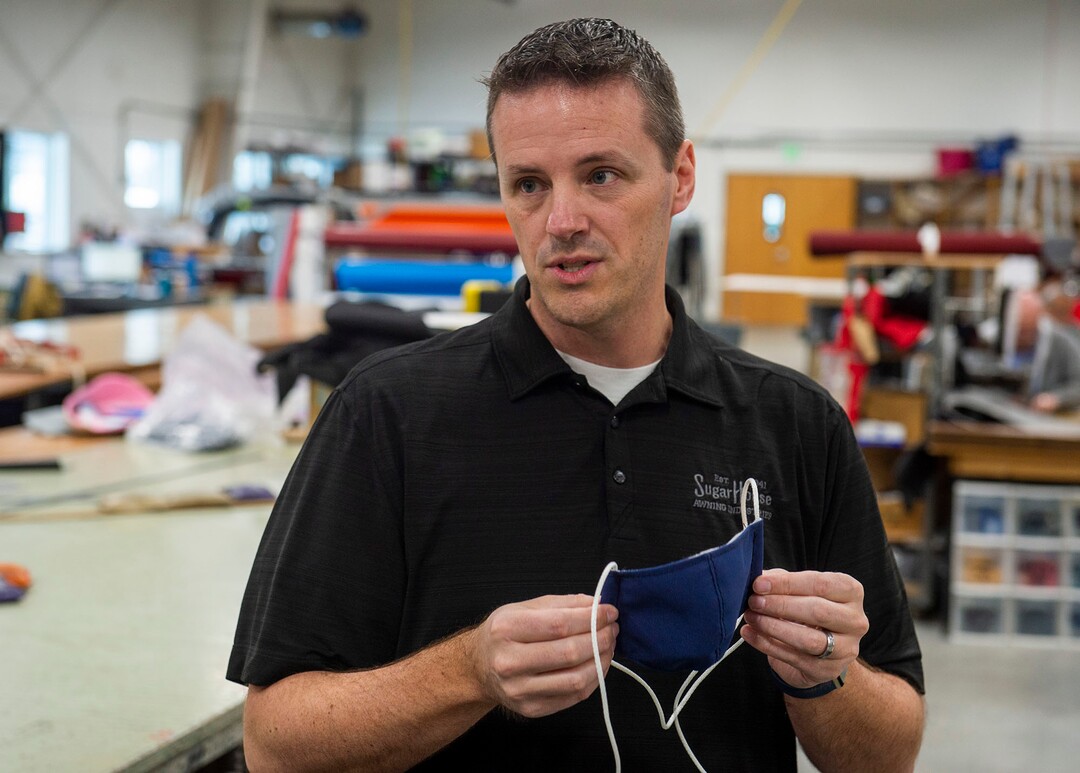 (Rick Egan  |  The Salt Lake Tribune)     Mike Peterson, president of SugarHouse Industries explains how they are using their industrial cutting and sewing machines to make face masks and face shields, to protect against coronavirus, Thursday, March 26, 2020.