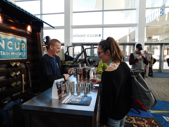 (Erin Alberty | The Salt Lake Tribune) A bartender serves samples of Tincup whiskey, at the Outdoor Retailer show Jan. 26, 2018 at the Colorado Convention Center in Denver.
