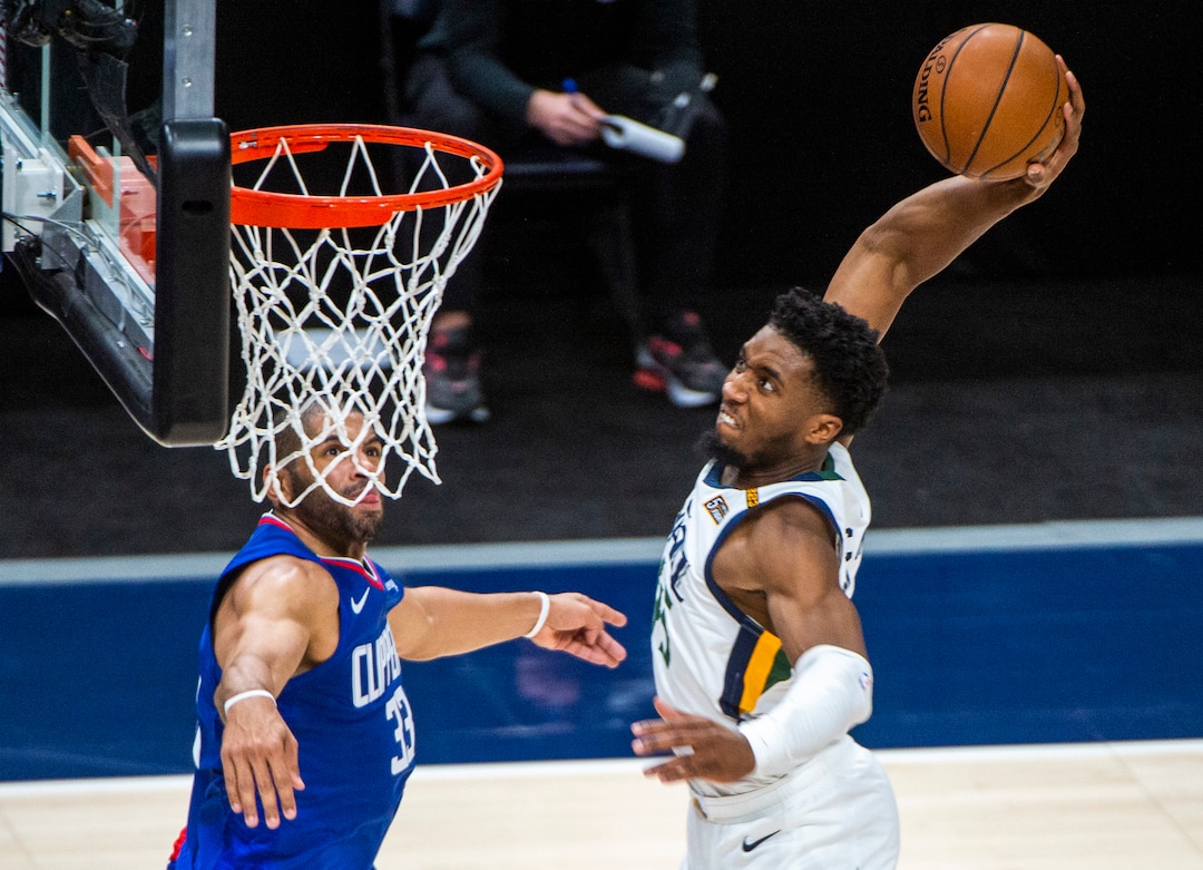 (Rick Egan | The Salt Lake Tribune) Utah Jazz guard Donovan Mitchell (45), dunks the ball, as  LA Clippers guard, Nicolas Batum (33) defends, in NBA action between the Utah Jazz and the LA Clippers at Vivint Arena, on Friday, Jan. 1, 2021.